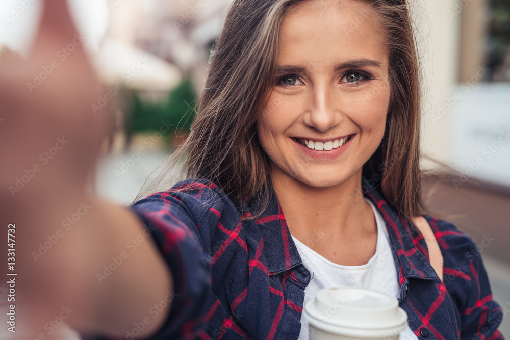 Attractive young woman taking a selfie in the city Attractive young woman taking a selfie in the city