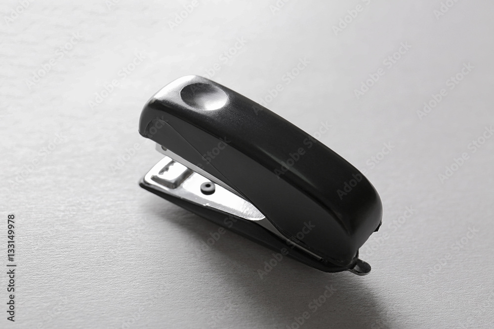 Black stapler on light background Black stapler on light background
