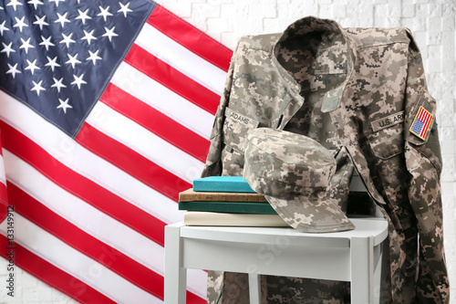 Canvastavla Chair, books, soldier uniform and USA flag near light textured wall