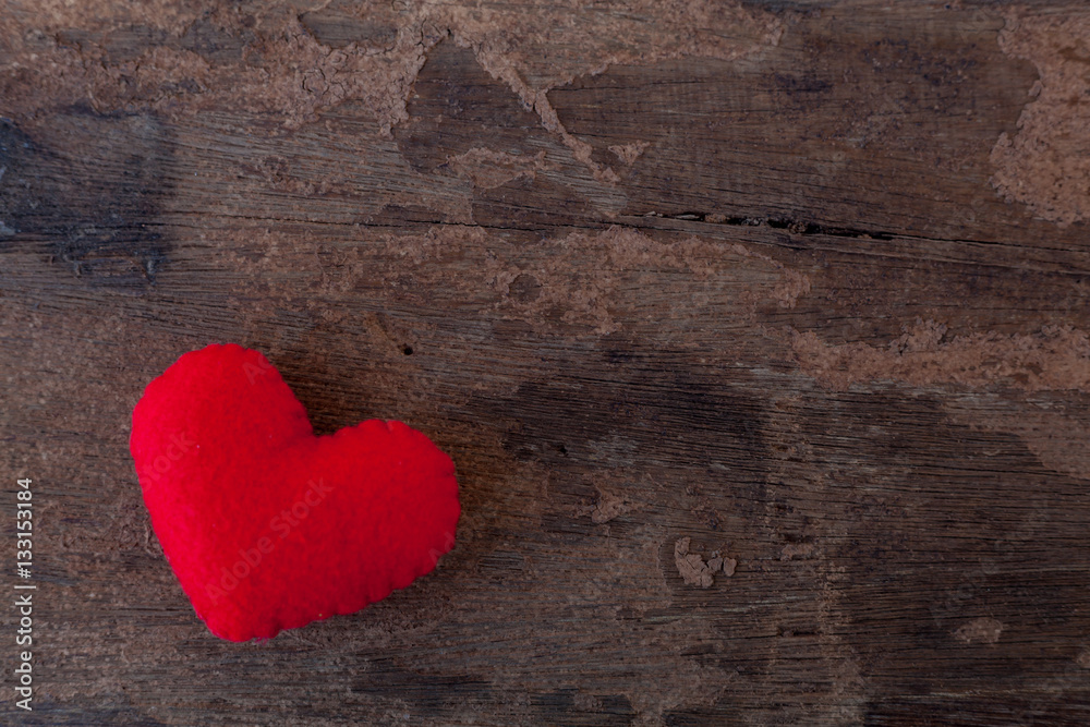 Red heart is placed on a wooden floor. Red heart is placed on a wooden floor.