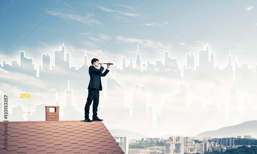 Engineer man standing on roof and looking in spyglass. Mixed med Engineer man standing on roof and looking in spyglass. Mixed med