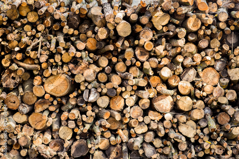 Heap of long wooden logs stacked horizontally Heap of long wooden logs stacked horizontally