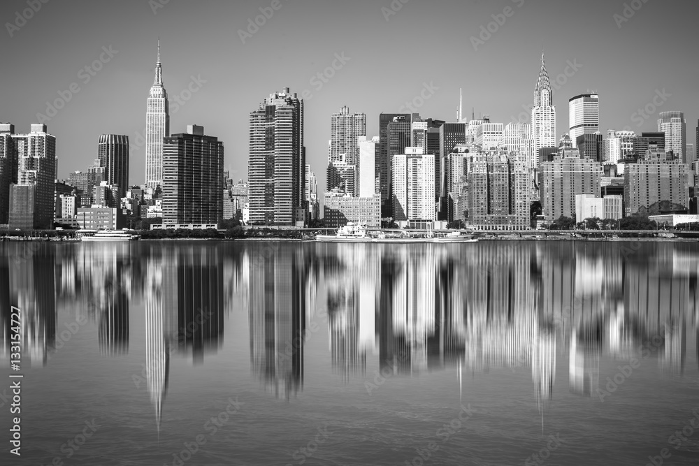 New York City view of Manhattan and The East River with reflections of NYC buildings in black and white