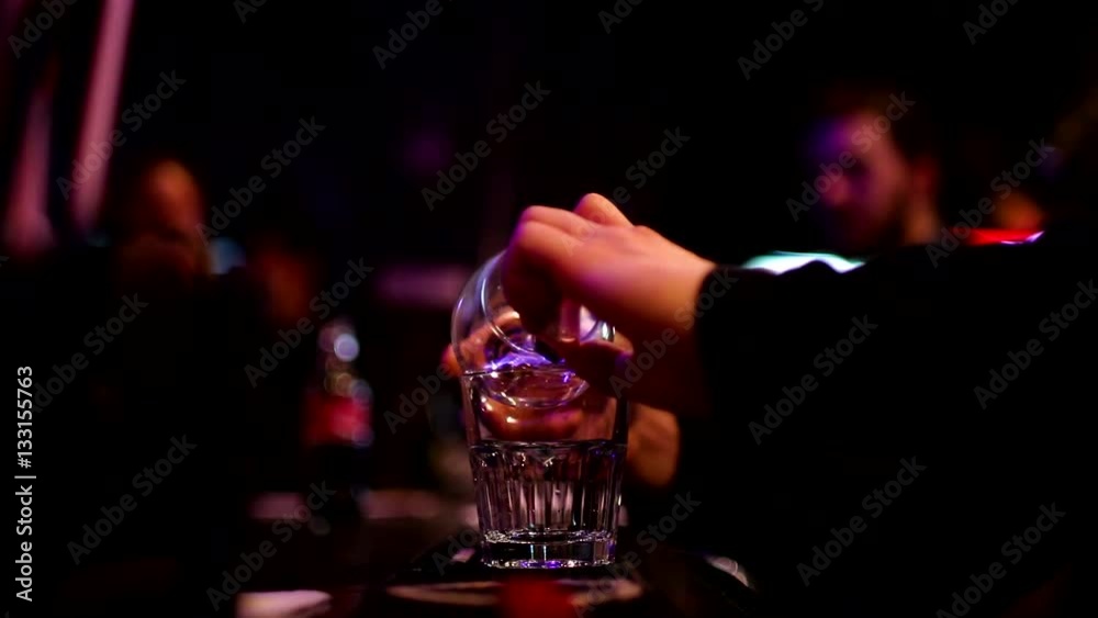 Barmen cooking Sambuca at the bar