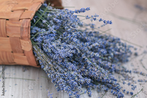 Lavender in the basket. Wooden background 