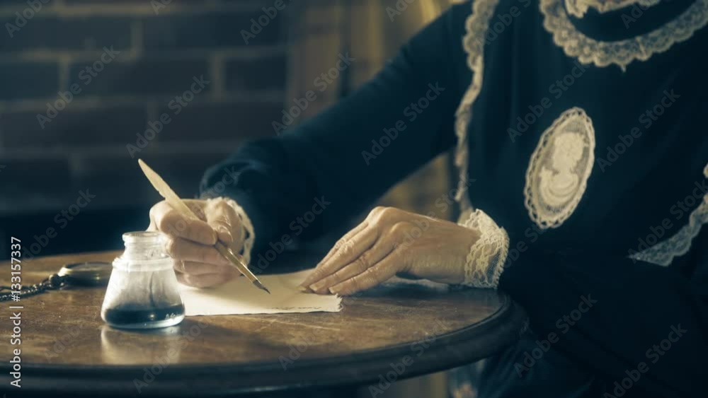 Mature hands of a Victorian era woman writing with a dip pen 4k