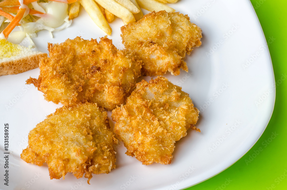 Fish Steaks, french fries with vegetables salad on a plate Fish Steaks, french fries with vegetables salad on a plate