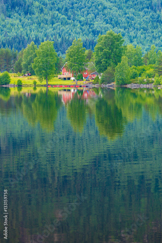 Norwegian country houses in mountains on lake shore