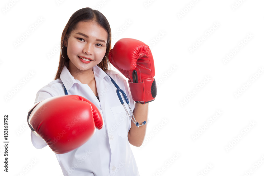 Young Asian female doctor punch with boxing glove.