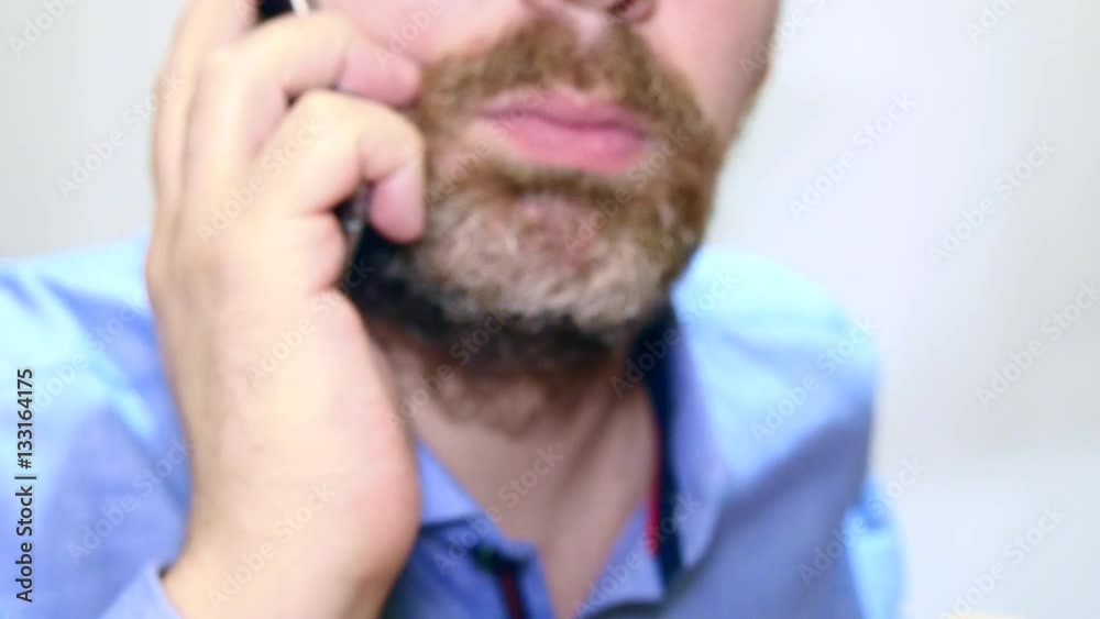 Bearded Man Talking At His Mobile Phone Bearded Man Talking At His Mobile Phone