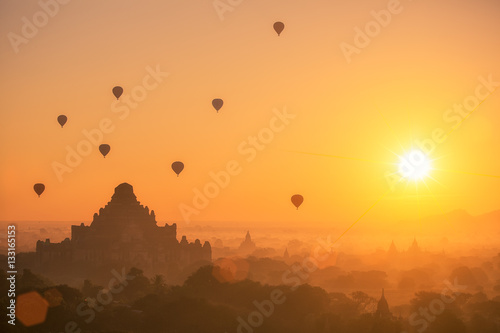 Hot air balloon over plain of Bagan in misty morning