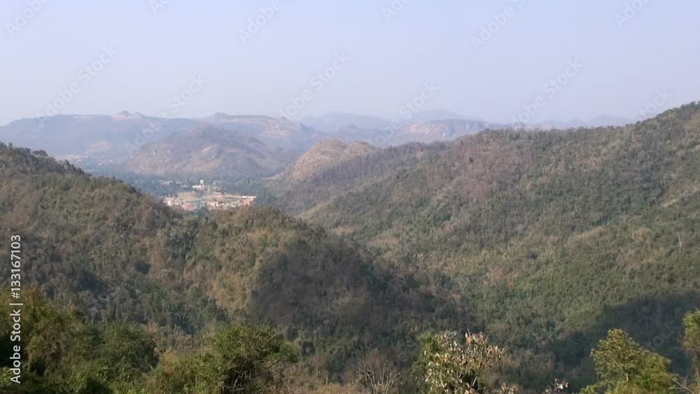 Zoom out from a jungle valley with a large quarry in the vale. A blue sky with small white clouds complete the scene. Zoom out from a jungle valley with a large quarry in the vale. A blue sky with small white clouds complete the scene.