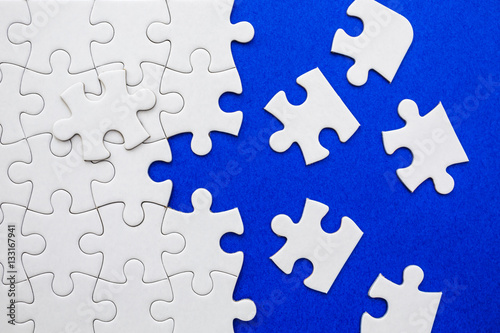 White puzzle elements on a blue background. 