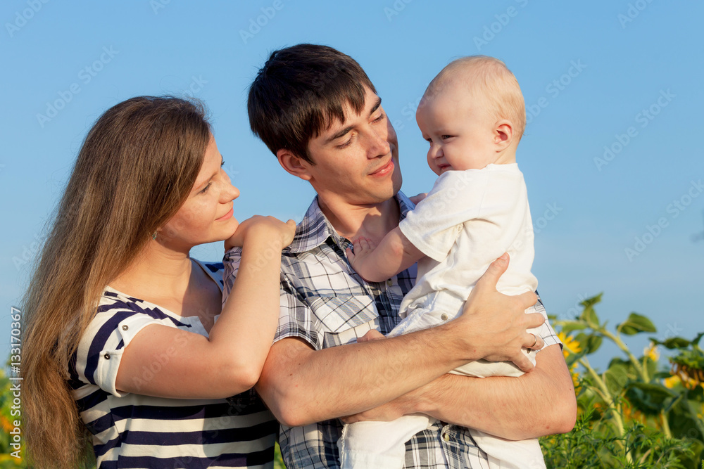 Happy family playing in park at the day time. Happy family playing in park at the day time.