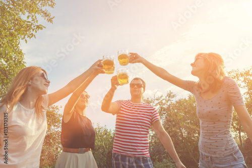 Friends enjoying outdoors with the beer.