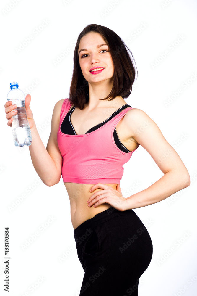 Young woman in sportswear with a bottle of drinking water