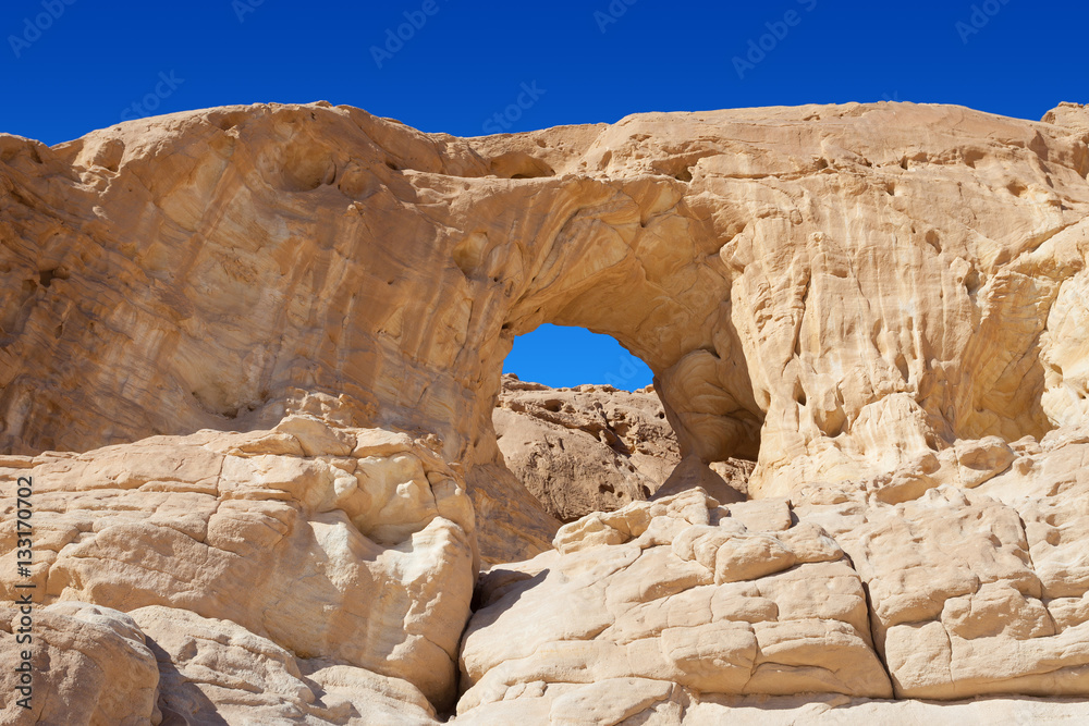 Timna park - The big arch with Desert landscape view Timna park - The big arch with Desert landscape view