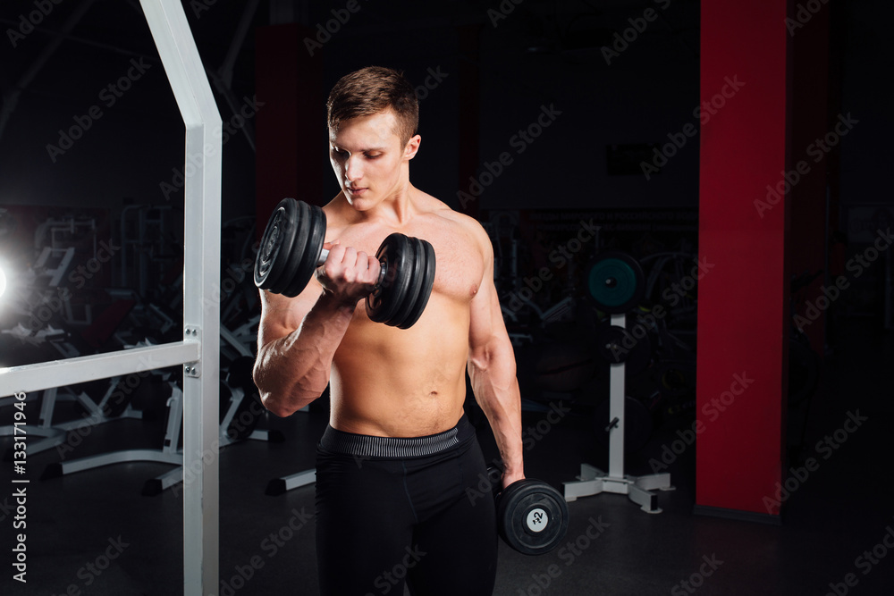 Closeup portrait of professional bodybuilder Strong muscular yang man doing exercise. Workout with barbell at gym. Sports and fitness. Training guy pumping up hands biceps. Closeup portrait of professional bodybuilder Strong muscular yang man doing exercise. Workout with barbell at gym. Sports and fitness. Training guy pumping up hands biceps.