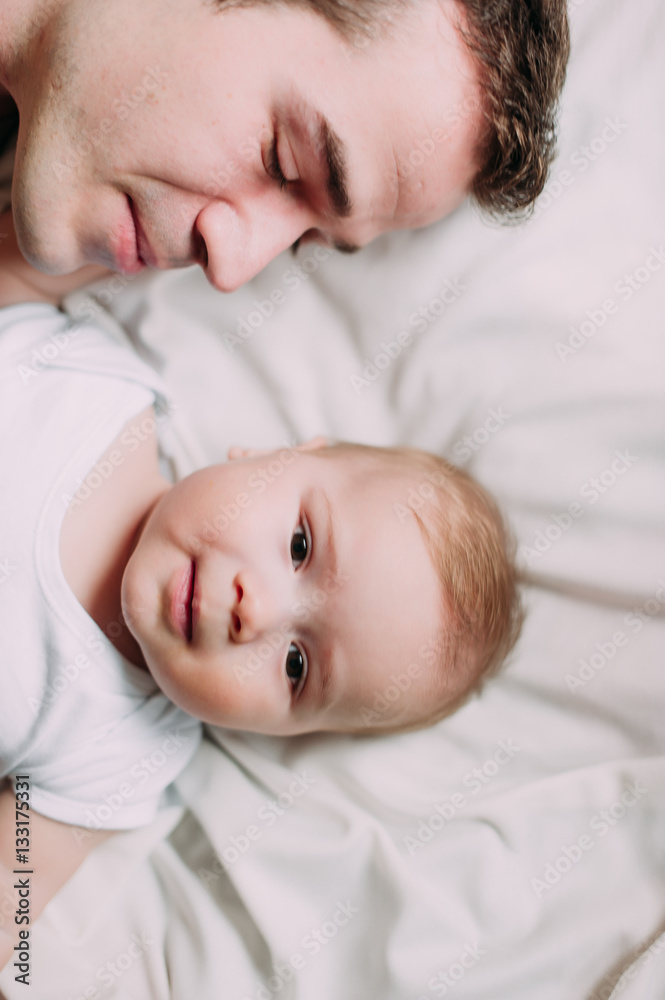 Portrait of loving father with baby boy 4-6 months his son at ho Portrait of loving father with baby boy 4-6 months his son at ho