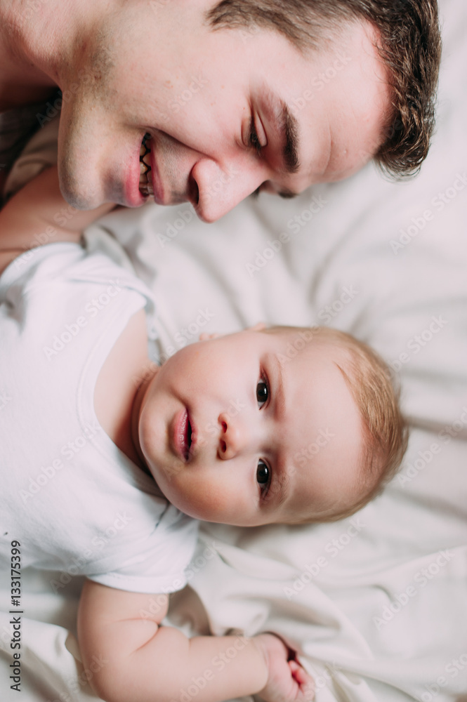 Portrait of loving father with baby boy 4-6 months his son at ho Portrait of loving father with baby boy 4-6 months his son at ho