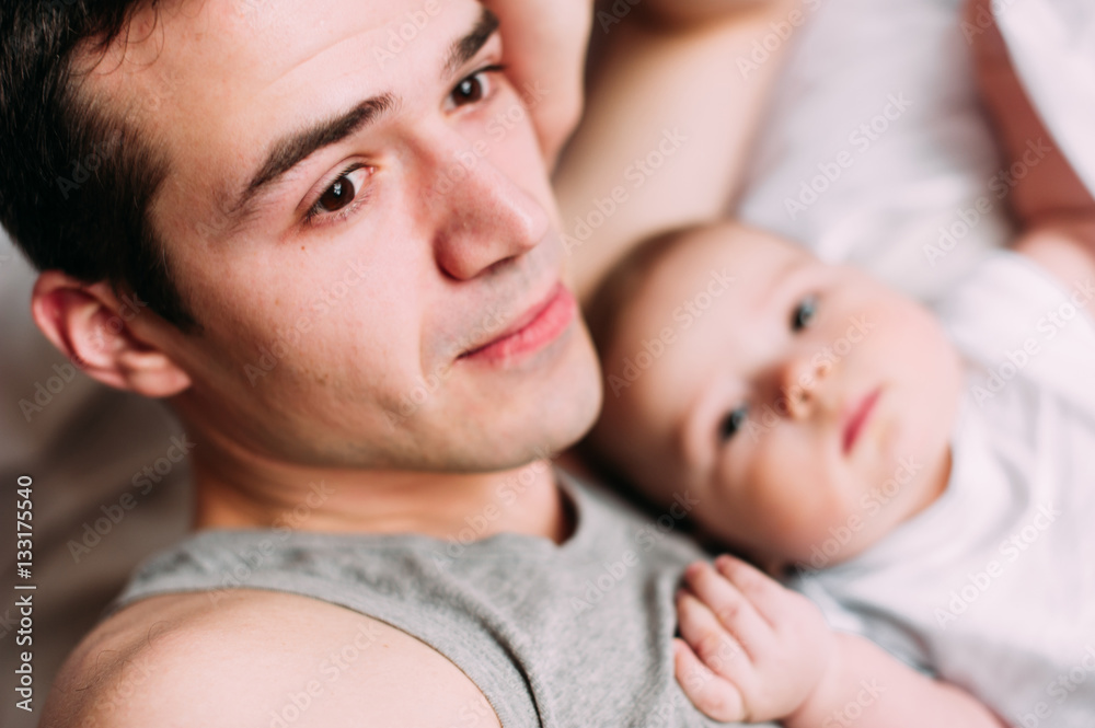Portrait of loving father with baby boy 4-6 months his son at ho Portrait of loving father with baby boy 4-6 months his son at ho