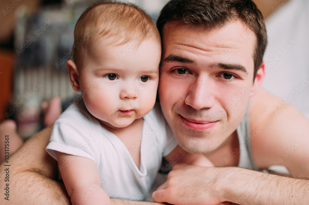 Portrait of loving father with baby boy 4-6 months his son at ho Portrait of loving father with baby boy 4-6 months his son at ho