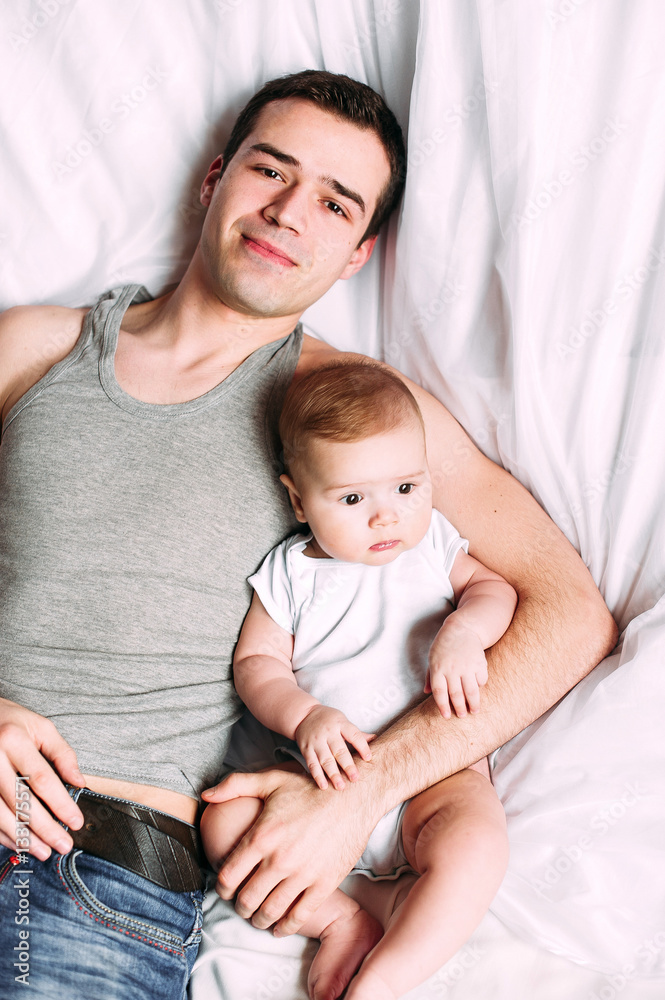 Portrait of loving father with baby boy 4-6 months his son at ho Portrait of loving father with baby boy 4-6 months his son at ho