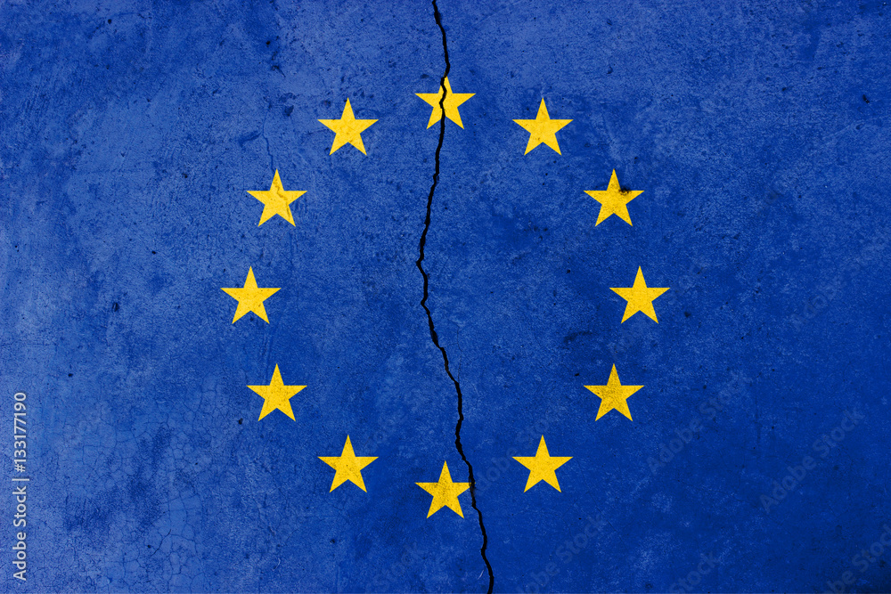 A crack in the wall. EU flag in the background A crack in the wall. EU flag in the background
