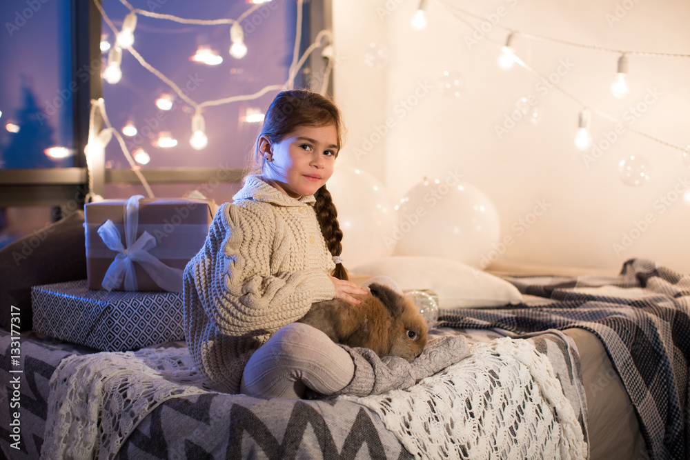 Very beautiful and charming little dark-haired girl in white swe Very beautiful and charming little dark-haired girl in white swe