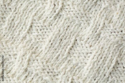 Knit texture of white wool knitted fabric with cable pattern as