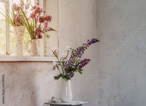 Fototapeta Naklejka Na Ścianę i Meble -  summer flowers on background old wall