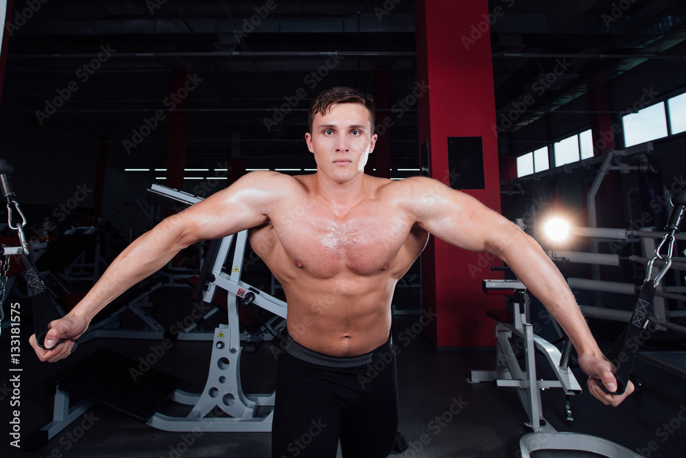 big strong bodybuider without shirts demonstrate crossover exercises. The pectoral muscles and hard training big strong bodybuider without shirts demonstrate crossover exercises. The pectoral muscles and hard training