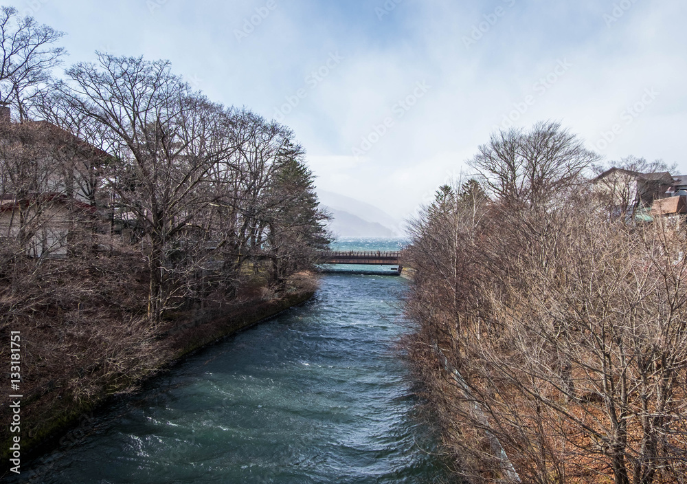 Bridge across river flow from lake, leads to Kegon falls in wint Bridge across river flow from lake, leads to Kegon falls in wint