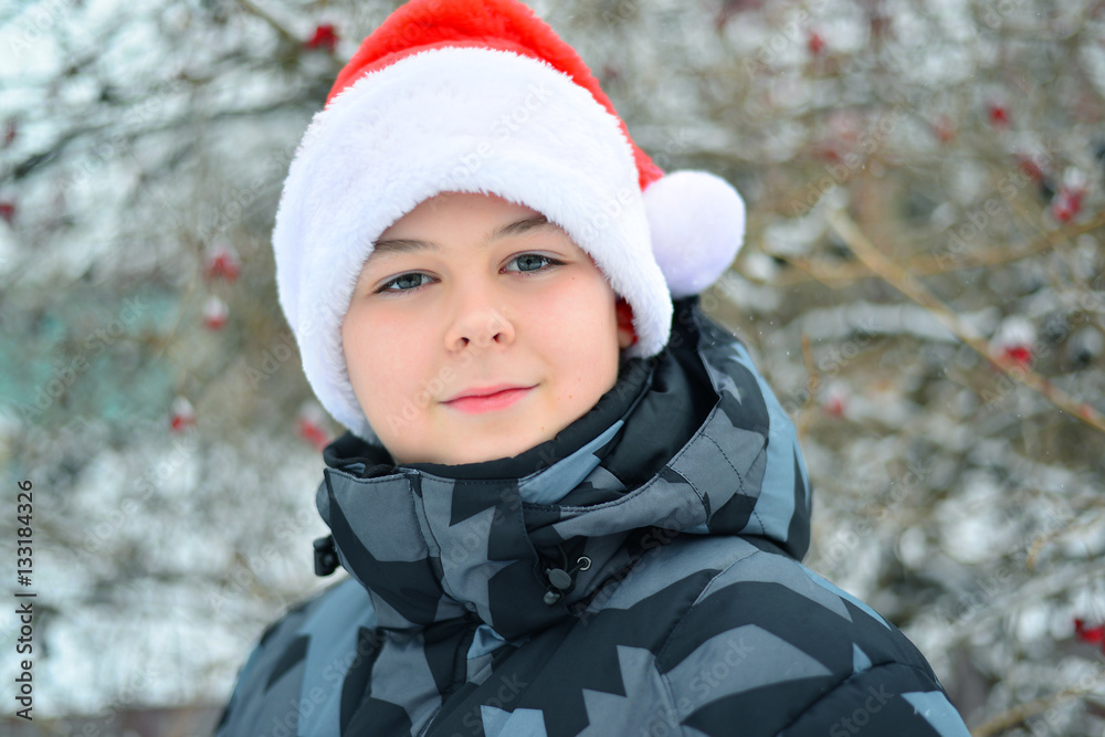 Teen boy in cap Santa Claus outdoor Teen boy in cap Santa Claus outdoor
