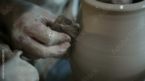 Potter works with clay. Making pots and other products