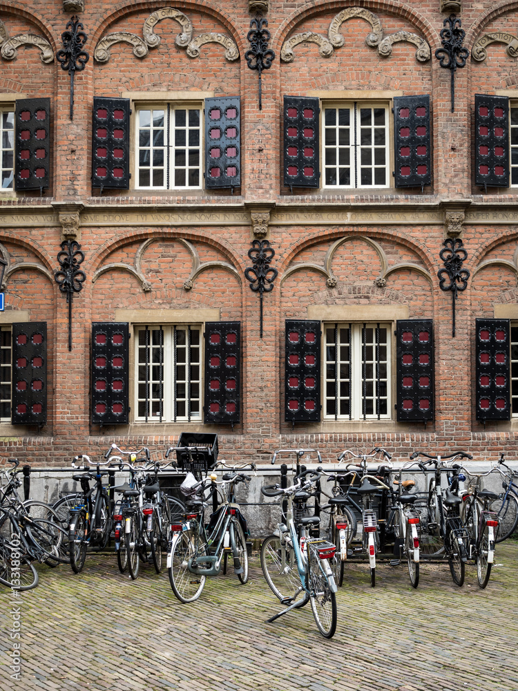 Dutch architectural façade. A traditional old building in the Dutch city of Nijmegen, Netherlands, fronted by bicycles.