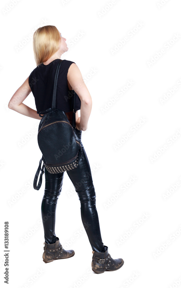 back view of standing young beautiful woman. girl watching. Rear view people collection. backside view of person. Long-haired blonde in leather pants put her hands on her hips. back view of standing young beautiful woman. girl watching. Rear view people collection. backside view of person. Long-haired blonde in leather pants put her hands on her hips.