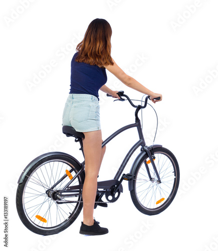 back view of a woman with a bicycle. cyclist sits on the bike. Rear view people collection. backside view of person.