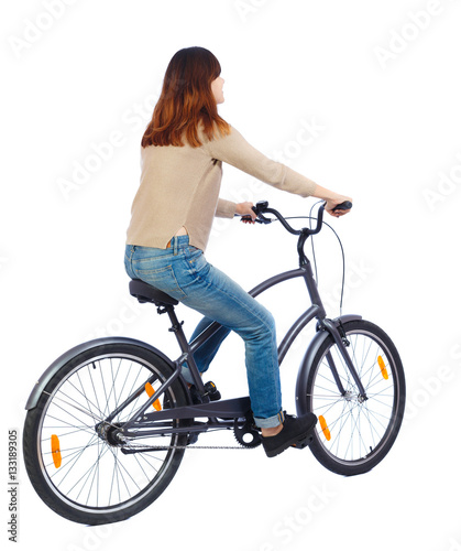 back view of a woman with a bicycle. cyclist sits on the bike. Rear view people collection. backside view of person. Isolated over white background. Brunette moves on a bicycle.