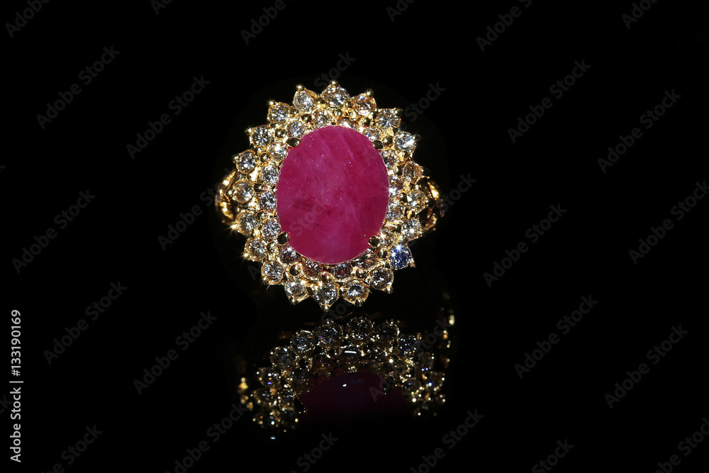 Jewellery diamond ring and gemstone on a black background