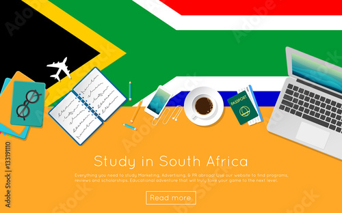 Study in South Africa concept for your web banner or print materials. Top view of a laptop, books and coffee cup on national flag. Flat style study abroad website header.