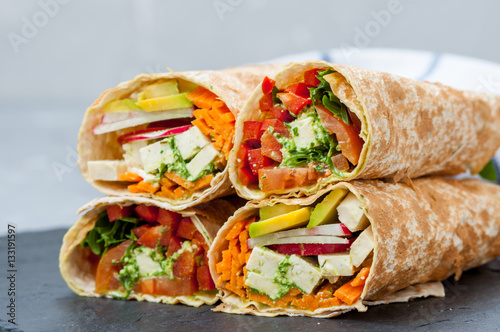 Healthy vegan salad tortilla wraps with tofu and vegetables. Love for a healthy raw food concept.