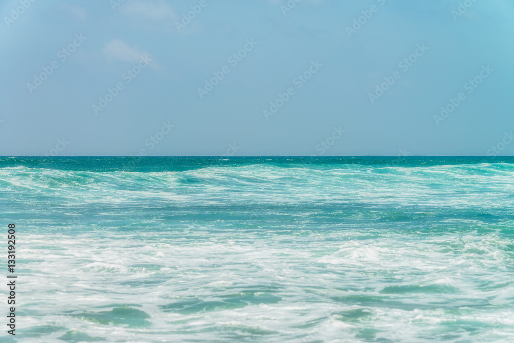 Sunny beach near Koggala - Sri Lanka. Waves of clear water and warm sand 