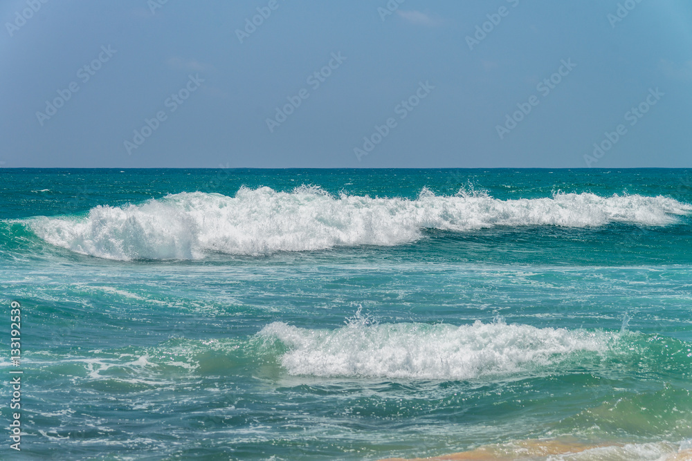 Fototapeta premium Sunny beach near Koggala - Sri Lanka. Waves of clear water and warm sand 