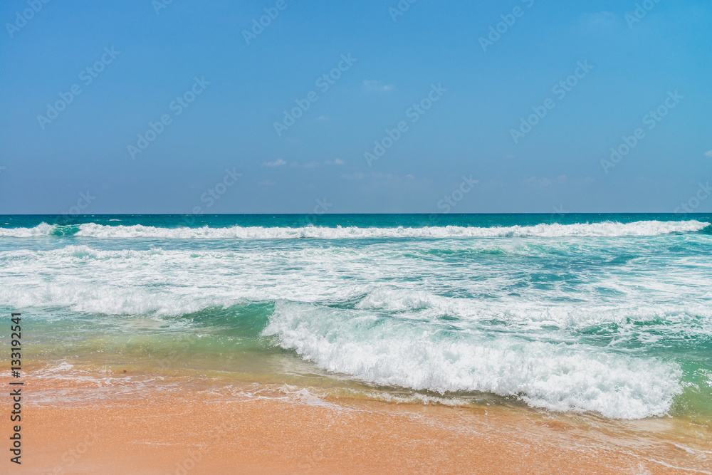 Sunny beach near Koggala - Sri Lanka. Waves of clear water and warm sand 