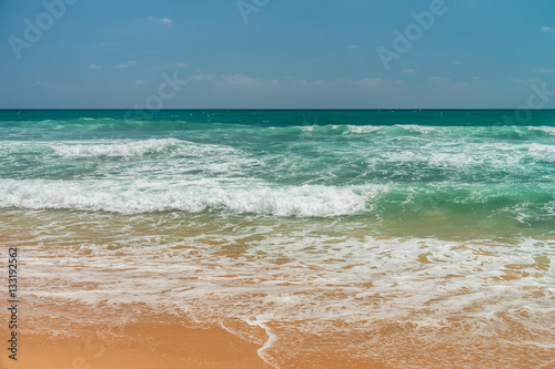 Sunny beach near Koggala - Sri Lanka. Waves of clear water and warm sand  photo