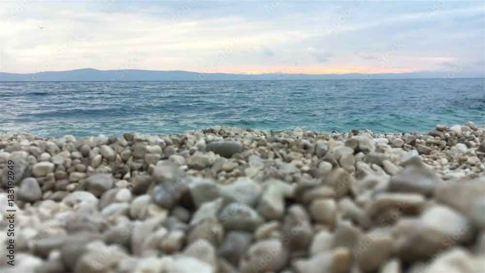 Slow motion landscape scene of pebble beach and sea with seagulls flying above 120 fps Slow motion landscape scene of pebble beach and sea with seagulls flying above 120 fps