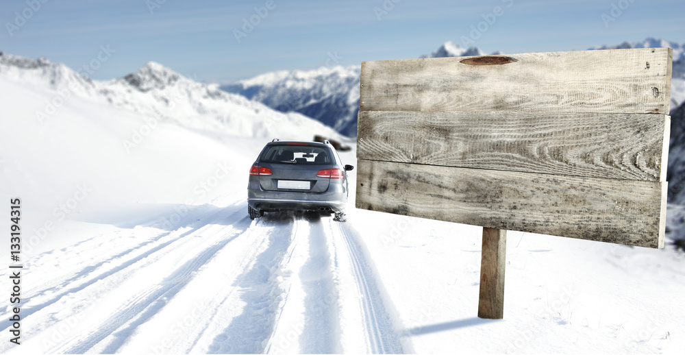 Fototapeta premium winter road and car with road sign 