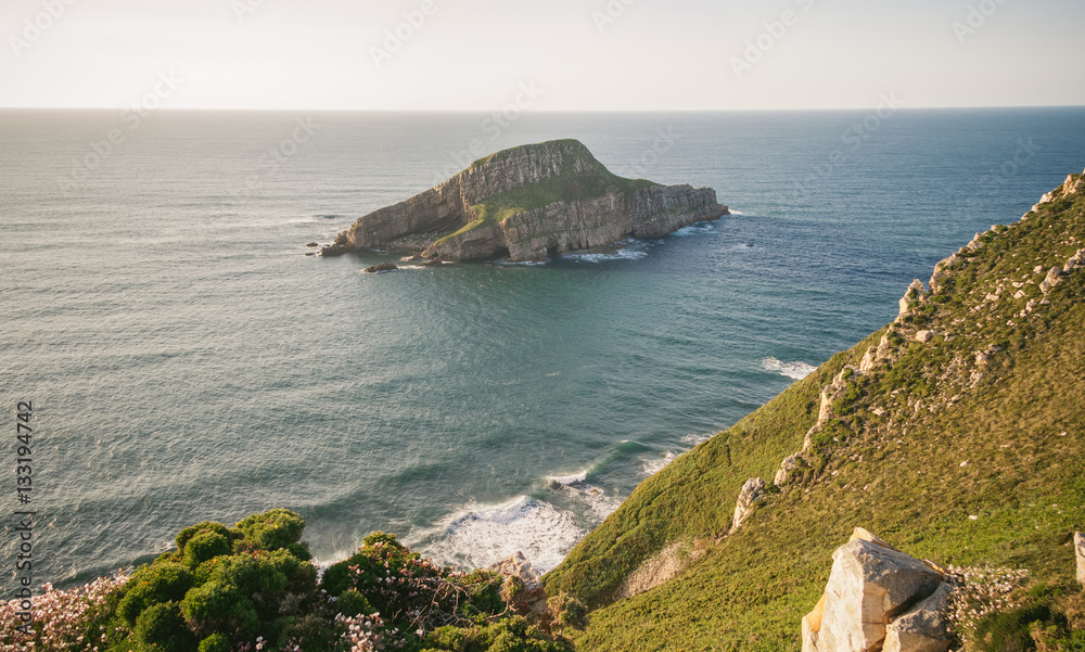 View of Deva island in a sunny day, in the coast of Bayas, Asturias, on Spain. It is the biggest island in all asturian coast.
