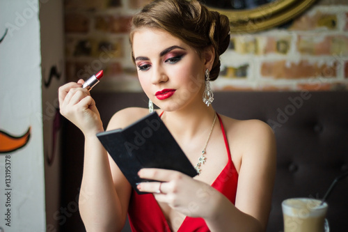 Wallpaper Mural Retro image. Girl paints her lips red lipstick. Close-up Torontodigital.ca